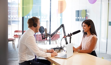 man interviewing woman radio studio